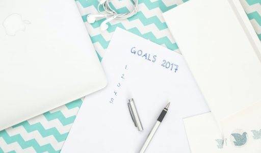 white earphones near papers
