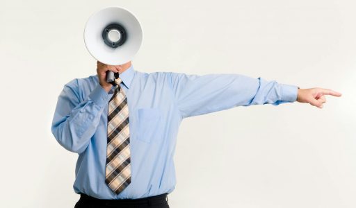 man with megaphone pointing